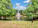 A serene pond featuring a fountain and lush greenery, offering a peaceful community space at 7511 Seurat St # 10207, Orlando, FL 32819