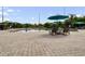 Community pool and deck area with lounge chairs and umbrellas overlooking the lake at 7511 Seurat St # 10207, Orlando, FL 32819