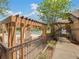 This community pool is located at the community clubhouse with pergola-covered seating areas and a gate entry at 7511 Seurat St # 10207, Orlando, FL 32819