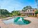 Beautiful community pool with brick pavers, lounge chairs, and nearby covered seating area for relaxing outdoors at 7511 Seurat St # 10207, Orlando, FL 32819