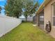 Lush backyard featuring a well-maintained lawn, privacy fence, and access to screened in lanai at 7513 Brightwater Pl, Oviedo, FL 32765