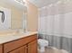 Clean bathroom featuring a vanity with ample storage and a shower with curtain at 7513 Brightwater Pl, Oviedo, FL 32765