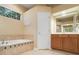 A bathroom features a tub, vanity, and tile flooring at 7513 Brightwater Pl, Oviedo, FL 32765