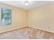 Bedroom with neutral walls, carpet flooring, and a window with lush exterior views at 7513 Brightwater Pl, Oviedo, FL 32765