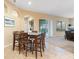 Bright dining area with a dark wood dining table, views of the backyard, and access to the living room at 7513 Brightwater Pl, Oviedo, FL 32765