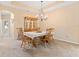 Elegant dining room featuring a chandelier, classic furniture, and neutral decor at 7513 Brightwater Pl, Oviedo, FL 32765