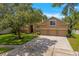 Beautiful two-story home boasting a three-car garage, manicured lawn, and classic curb appeal at 7513 Brightwater Pl, Oviedo, FL 32765
