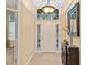 Inviting foyer with natural light, decorative light fixture, and a stylish console table at 7513 Brightwater Pl, Oviedo, FL 32765