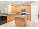 A spacious kitchen featuring stainless steel appliances and an island at 7513 Brightwater Pl, Oviedo, FL 32765