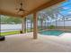 Inviting screened lanai with a ceiling fan, offering views of the sparkling pool and yard at 7513 Brightwater Pl, Oviedo, FL 32765