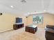 Cozy living room featuring neutral carpet, modern entertainment center, and sunlit window at 7513 Brightwater Pl, Oviedo, FL 32765