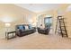 Spacious living room with large windows overlooking the pool area at 7513 Brightwater Pl, Oviedo, FL 32765