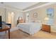 Bright main bedroom with tray ceiling, carpeted floor, and ensuite bathroom access at 7513 Brightwater Pl, Oviedo, FL 32765