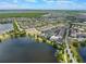 Panoramic aerial view featuring a lakefront community surrounded by lush greenery at 8478 Karrer Ter, Orlando, FL 32827