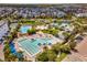 An aerial view of the community with multiple pools, palm trees, and beautiful landscaping at 8478 Karrer Ter, Orlando, FL 32827