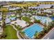 Resort-style community pool area with multiple pools, palm trees, volleyball court and lots of seating at 8478 Karrer Ter, Orlando, FL 32827