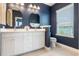 Bathroom boasting a double sink vanity with granite counters, framed mirrors, and toilet at 8478 Karrer Ter, Orlando, FL 32827
