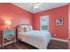 Bedroom featuring a queen size bed, ceiling fan and decorated side table next to the window at 8478 Karrer Ter, Orlando, FL 32827