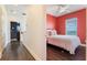 Bedroom with a large window and ceiling fan featuring a queen bed with white bedding at 8478 Karrer Ter, Orlando, FL 32827