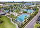 Aerial view of community pool area with lap pool, clubhouse, and lounge seating at 8478 Karrer Ter, Orlando, FL 32827