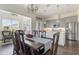 Open-concept kitchen and dining area with stainless steel appliances and stylish pendant lighting at 8478 Karrer Ter, Orlando, FL 32827