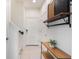 Bright entryway with neutral tile flooring, stairs, and built in shelving with modern decor at 8478 Karrer Ter, Orlando, FL 32827