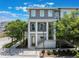 Charming three-story townhome featuring a modern design with lush landscaping and a welcoming entrance at 8478 Karrer Ter, Orlando, FL 32827
