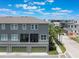 Stylish three-story home with balconies and a garage, complemented by palm trees at 8478 Karrer Ter, Orlando, FL 32827