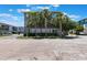Stylish multi-story home featuring mature palm trees and manicured landscaping at 8478 Karrer Ter, Orlando, FL 32827
