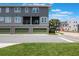 Modern three-story townhome with green garage doors and balcony seating at 8478 Karrer Ter, Orlando, FL 32827