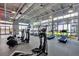 Spacious gym with modern treadmills, elliptical machines, and large windows for ample lighting at 8478 Karrer Ter, Orlando, FL 32827