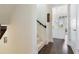 Bright hallway with hardwood floors and access to the kitchen with white cabinets at 8478 Karrer Ter, Orlando, FL 32827