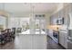 Charming kitchen featuring stainless steel appliances, a center island, and stylish pendant lighting at 8478 Karrer Ter, Orlando, FL 32827