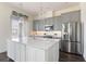 Modern kitchen with stainless steel appliances, a center island, and stylish gray cabinetry at 8478 Karrer Ter, Orlando, FL 32827