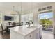 Open kitchen and dining area with stainless steel appliances, an island, and plenty of seating at 8478 Karrer Ter, Orlando, FL 32827