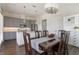 Open floor plan kitchen and dining area with stainless steel appliances and dark wood dining table at 8478 Karrer Ter, Orlando, FL 32827