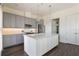Well-lit kitchen boasts a large center island, stainless steel appliances, and ample cabinet space at 8478 Karrer Ter, Orlando, FL 32827