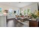 Open-concept living room with comfortable seating, a decorative coffee table, and bright natural lighting at 8478 Karrer Ter, Orlando, FL 32827