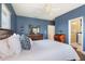 Comfortable main bedroom featuring a ceiling fan, wooden furniture, and ensuite bathroom at 8478 Karrer Ter, Orlando, FL 32827