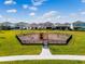 Community playground with wooden climbing structure set within a fenced, grassy park at 8478 Karrer Ter, Orlando, FL 32827
