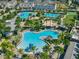 Resort-style community pool area with palm trees, lounge chairs, and blue umbrellas at 8478 Karrer Ter, Orlando, FL 32827