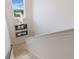 Upstairs stairway with carpet, white walls, and a sunny window with a view of the lake at 8478 Karrer Ter, Orlando, FL 32827