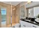 Modern bathroom featuring glass shower, granite counters, and views at 101 S Eola Dr # 810, Orlando, FL 32801