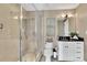 Well-lit bathroom with a glass-enclosed shower, neutral tiling and modern fixtures at 101 S Eola Dr # 810, Orlando, FL 32801