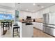 Bright kitchen with white cabinets, black countertops, and stainless steel appliances, open to dining area at 101 S Eola Dr # 810, Orlando, FL 32801