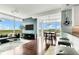 Open-concept living area with floor-to-ceiling windows, views, dining area, and modern furnishings at 101 S Eola Dr # 810, Orlando, FL 32801