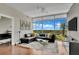 Bright living room with floor-to-ceiling windows, modern sofa, and views of the surrounding landscape at 101 S Eola Dr # 810, Orlando, FL 32801