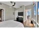 Well-lit main bedroom with hardwood floors, TV, and balcony entrance at 101 S Eola Dr # 810, Orlando, FL 32801