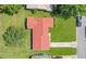 Aerial view of a home with a red tile roof, surrounded by a green lawn and neighboring houses at 10148 Eventide Ct, Orlando, FL 32821
