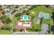An aerial view of a community pool, tennis court, bocce ball, and shuffleboard near neatly arranged homes at 10148 Eventide Ct, Orlando, FL 32821